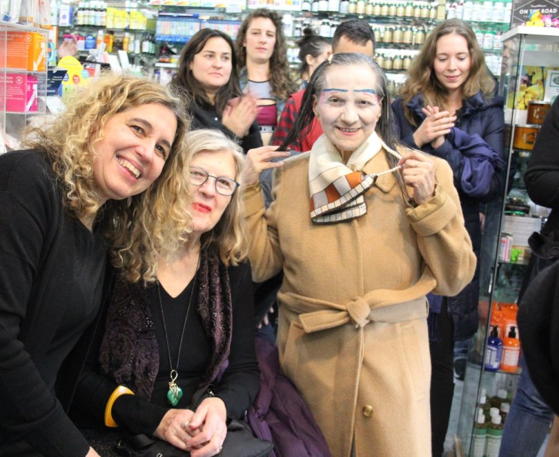 Jolie Alony standing inside Thompson Alchemists and smiling for picture with several of the retail stores customers