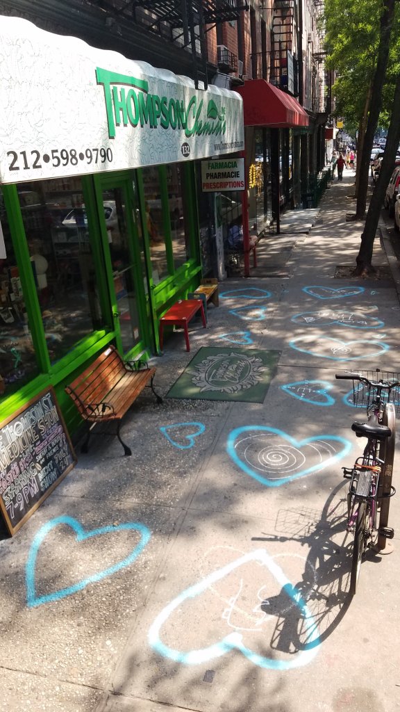 Hash Halpern painted hearts in front of Thompson Alchemists