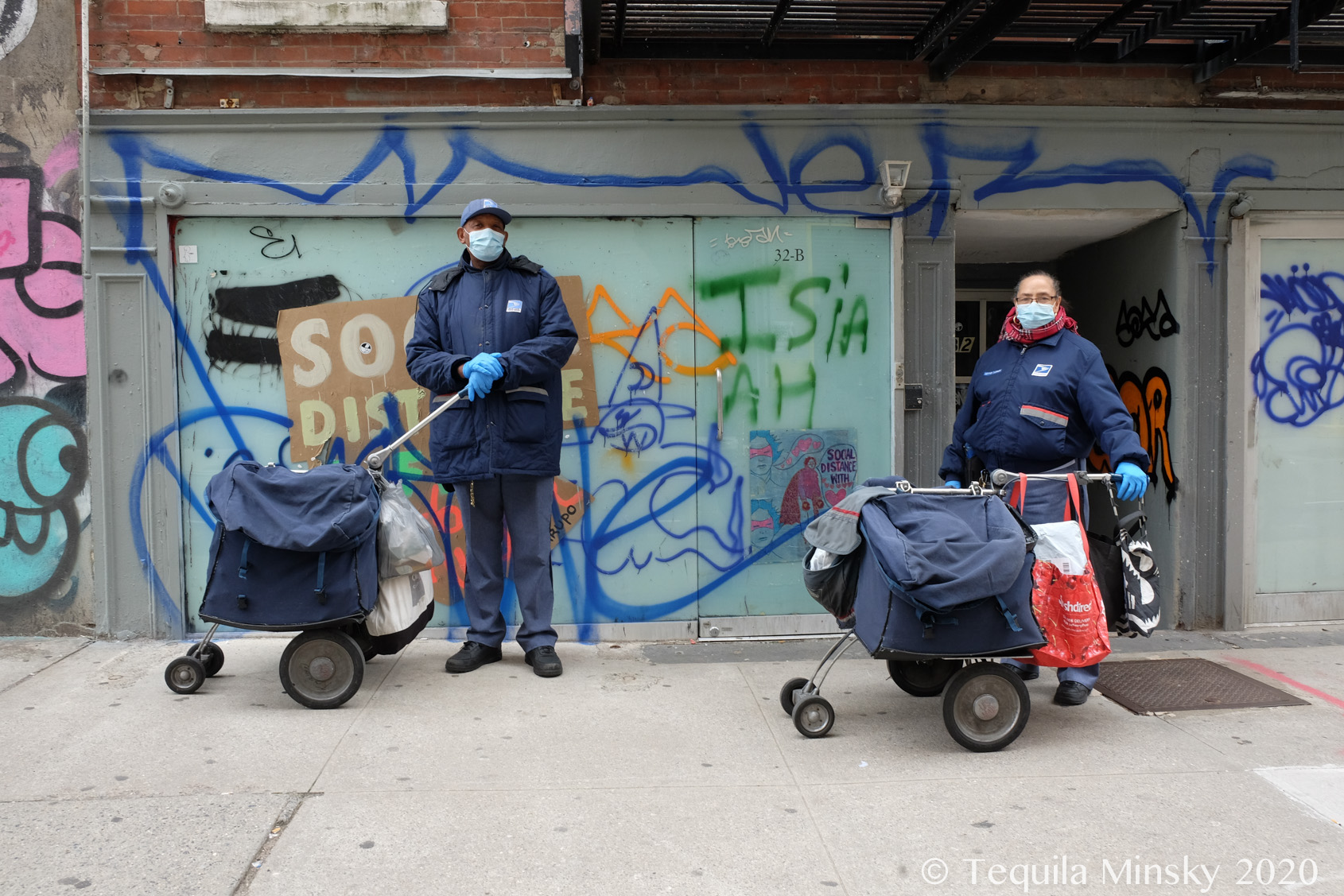 Two mail carriers on Thompson Street in New York City 