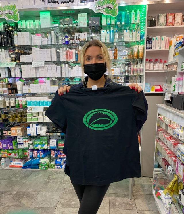 Lauren from the Soho Grand Hotel holding a Thompson Alchemists T-shirt 